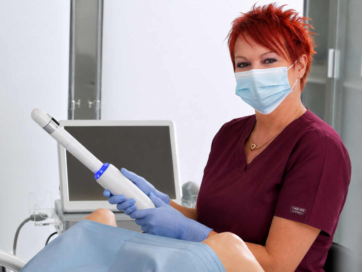 Practitioner in scrubs holding the HIFU applicator beside a patient during an intimate rejuvenation treatment at Redmayne Lodge